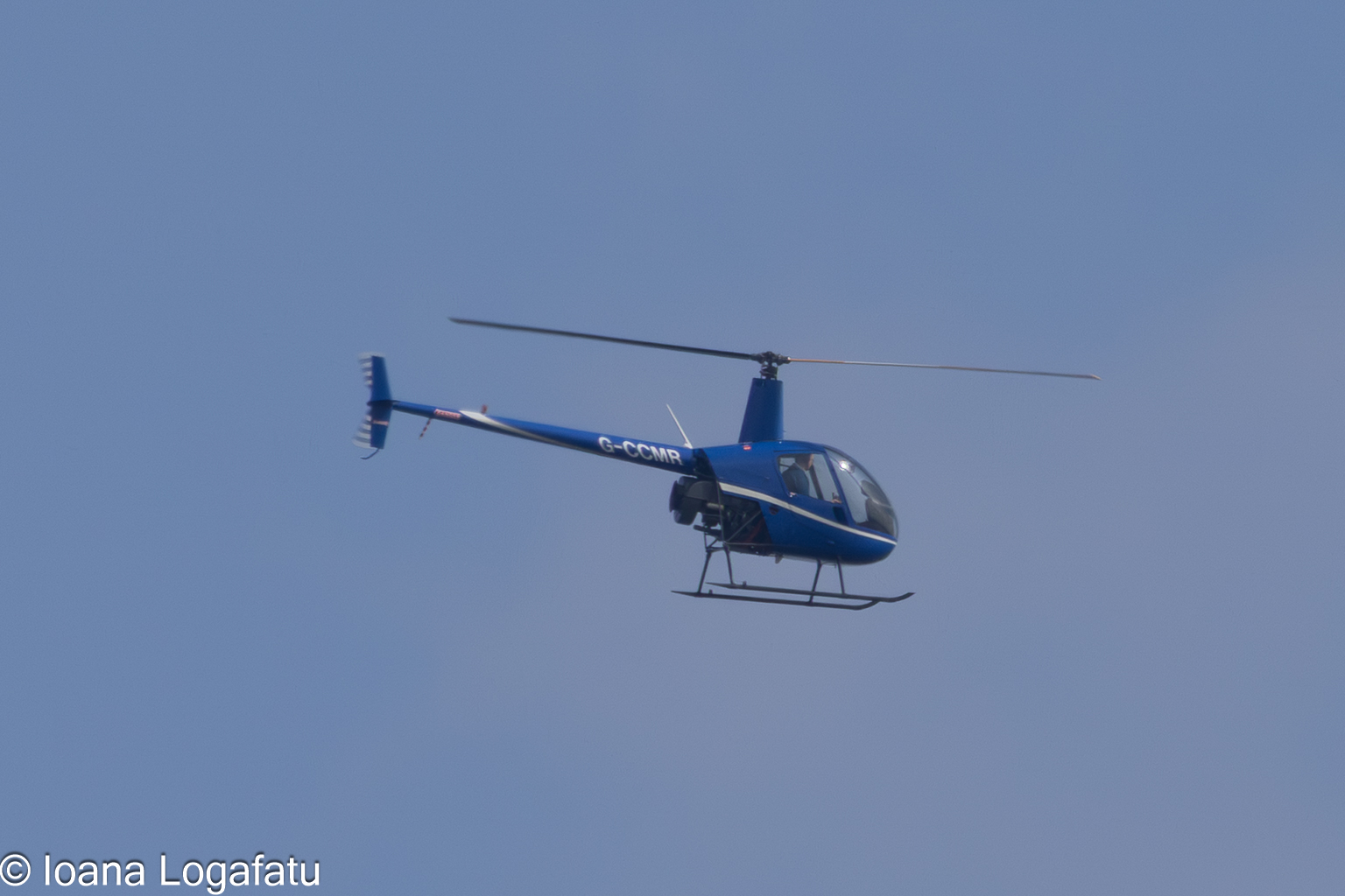 Helicopter soaring high above the serene landscape